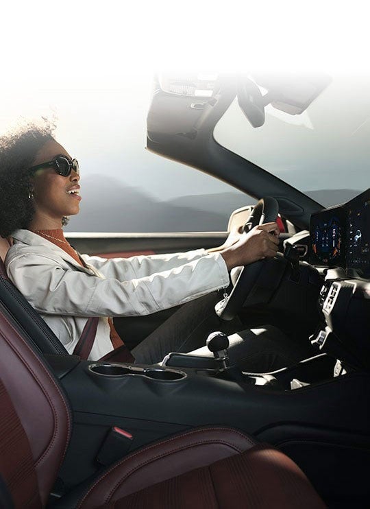 Person sitting in the driver’s seat of a 2024 Ford Mustang® convertible | Sawgrass Ford in Sunrise FL